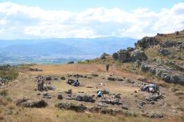 From a distance we see a circle of stones on a mountainside.